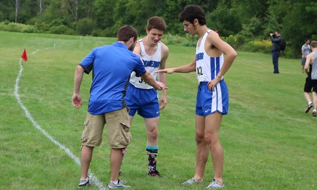 Coach Bartman huddles with Clane Newcomer (L) and Gabriel LoBaido (R) prior to race.